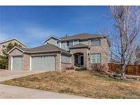 Charming two-story home with a three-car garage and well-manicured lawn at 16590 Hitching Post Cir, Parker, CO 80134