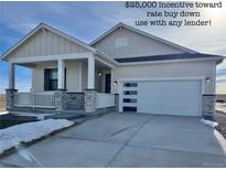 Charming single-story home featuring a covered porch with stone accents and a modern garage door with window details at 42974 Colonial Trl, Elizabeth, CO 80107