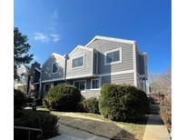 Two-story home showcasing gray siding, white trim, and well-maintained landscaping under a clear blue sky at 6585 W 84Th Way # 109, Arvada, CO 80003