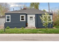 Charming home featuring a well-maintained lawn, a blossoming tree, and a neatly painted facade at 3740 W 54Th Ave, Denver, CO 80221