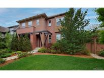 Charming two-story home with landscaped front yard, walkway, and inviting covered entryway at 8044 E 24Th Ave, Denver, CO 80238