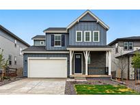 Charming two-story home with a two-car garage and a welcoming front porch at 7267 Prairie Sage Pl, Littleton, CO 80125