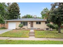 Charming ranch-style home with a well-maintained front yard and a classic brick exterior at 3054 S Raleigh St, Denver, CO 80236