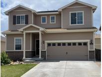 Charming two-story home featuring a two-car garage, inviting front porch, and neutral exterior color palette at 9535 Dexter Ln, Thornton, CO 80229