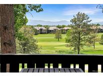 Scenic golf course view with lush green fairways, mature trees, and beautiful mountain backdrop from the deck at 2525 S Dayton Way # 1510, Denver, CO 80231