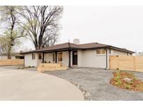 Charming single-story home with a spacious yard, contemporary landscaping, and a welcoming entrance at 4395 Newland St, Wheat Ridge, CO 80033