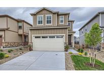 Charming two-story home with a two car garage and neutral colored exterior at 16135 Mountain Flax Dr, Monument, CO 80132