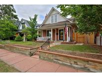 Charming brick home with a welcoming front porch and well-maintained landscaping at 482 S Logan St, Denver, CO 80209