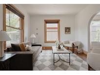 Bright living room featuring large windows, modern decor, and stylish furnishings creating a welcoming ambiance at 461 S Sherman St, Denver, CO 80209
