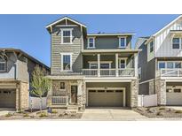 Charming two-story home with a two-car garage, stone accents and inviting front porch at 2138 S Haleyville Way, Aurora, CO 80018