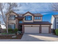 Charming two-story home with three-car garage and landscaped front yard at 9586 W Victoria Dr, Littleton, CO 80128