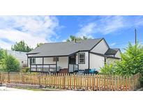 Charming home with a covered porch and a picket fence at 3275 W Hawthorne Pl, Denver, CO 80221
