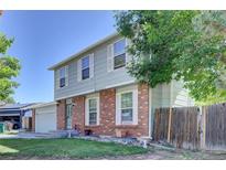Charming two-story home featuring a brick facade, light grey siding, and well-maintained front yard at 17825 E Carolina Pl, Aurora, CO 80017