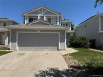 Traditional two-story home showcasing a two-car garage and concrete driveway on a bright, sunny day at 20787 E 39Th Ave, Denver, CO 80249