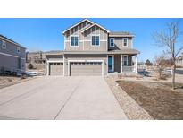 Charming two-story home featuring a three-car garage, landscaped front yard, and welcoming front porch at 5367 Spring Ridge Trl, Castle Rock, CO 80104