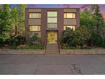 Exterior view of building with brick facade, large windows, and landscaped entryway at 1144 N Ogden St # 304, Denver, CO 80218