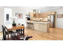 Modern kitchen features stylish cabinets, stainless steel appliances, and a center island with barstool seating at 3933 Inca St, Denver, CO 80211