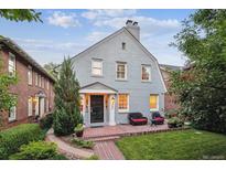 Charming two-story home with brick walkway and inviting front porch seating area at 428 N Humboldt St, Denver, CO 80218