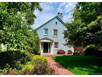 Charming painted brick home with a landscaped front yard and a welcoming brick pathway at 428 N Humboldt St, Denver, CO 80218