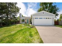 Charming single-Gathering home with a two-car garage and a well-manicured front lawn at 9376 W Wagon Trail Cir, Littleton, CO 80123