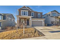 Two-story home with attached garage and landscaped yard at 5044 Basalt Ridge Cir, Castle Rock, CO 80108