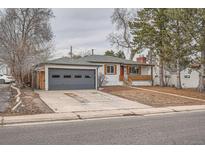 Charming single-story home featuring a gray garage door and a welcoming red front door at 3361 S Dahlia St, Denver, CO 80222