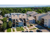 An aerial view of modern condos and a well-maintained landscape on a sunny day at 6007 Yarrow St # D, Arvada, CO 80004