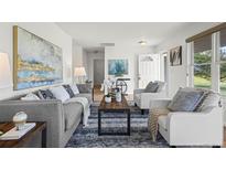 Bright and airy living room featuring modern decor and comfortable seating arrangement at 46531 Sundance Trl, Parker, CO 80138