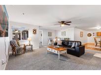 Comfortable living room with plush carpet, ceiling fan, and lots of natural light at 5425 County Road 32 # 27, Mead, CO 80504