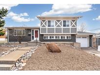 An inviting two-story home with a unique brick and grey facade and a low-maintenance front yard at 7668 Ellen Ln, Denver, CO 80221