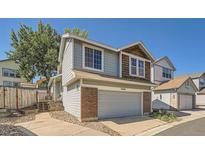 Charming home featuring a two-car garage, beautiful brick accents, and tasteful siding at 10440 W 83Rd Ave, Arvada, CO 80005