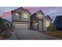 Charming two-story home with blue siding, a gray roof, and a spacious two-car garage with driveway at 1715 Pioneer Cir, Lafayette, CO 80026