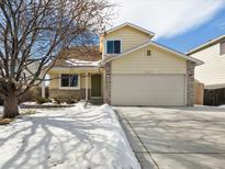 Charming two-story home with a well-maintained lawn and attached two-car garage at 13577 Quivas St, Denver, CO 80234