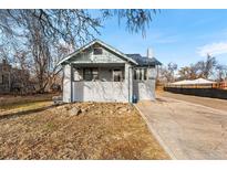 Brick house with front porch and driveway, offering curb appeal at 6145 W 38Th Ave, Wheat Ridge, CO 80033