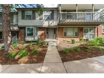 Two-story townhome with brick and siding exterior, landscaping, and a walkway at 7114 E Briarwood Dr, Centennial, CO 80112