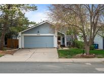 Charming single-Gathering home showcasing a well-kept lawn, driveway, and attached two-car garage at 17613 E Ohio Cir, Aurora, CO 80017