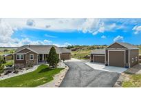 Beautiful home featuring a long driveway leading to an attached and detached garage at 555 Heritage Trl, Elizabeth, CO 80107