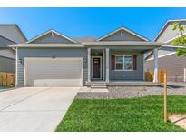 Charming single-story home with a well-manicured lawn and an attached two-car garage at 13487 Valentia St, Thornton, CO 80602