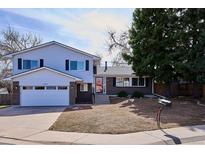 Charming two-story home with brick and vinyl siding, an attached garage, and a well-maintained front yard at 13088 W Arkansas Pl, Lakewood, CO 80228