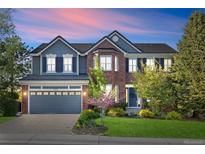 Charming two-story home featuring brick and siding, complemented by a well-maintained lawn and professional landscaping at 17925 E Maplewood Dr, Aurora, CO 80016