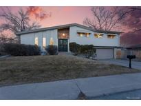 Inviting two-story home featuring unique stone accents and a well-maintained front yard at 8521 E Cornell Dr, Denver, CO 80231