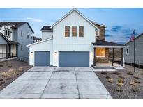 Charming two-story home featuring a modern farmhouse design with a two-car garage and covered porch at 875 Coal Bank Trl, Castle Rock, CO 80104