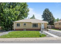 Charming brick home with a well-manicured lawn and mature trees in a desirable neighborhood at 2582 S Uno Way, Denver, CO 80219