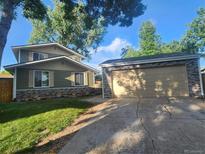 Charming home featuring a lush lawn, mature trees, and a detached two-car garage at 6207 W 92Nd Pl, Westminster, CO 80031