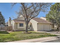 Charming home with a two-car garage, manicured lawn, and mature landscaping at 4272 E 126Th Pl, Thornton, CO 80241