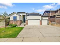Charming home with a three-car garage, stone accents, and well-maintained lawn at 6829 Juniper Ct, Frederick, CO 80530
