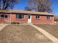 Charming brick home with a well-maintained lawn and inviting front entrance at 2101 S Lowell Blvd, Denver, CO 80219