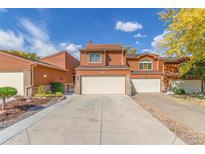 Charming two-story home with attached two-car garage and well-manicured landscaping at 119 Ward Ct, Lakewood, CO 80228