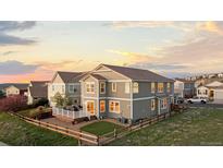 Lovely backyard featuring a deck, fenced yard, and well-maintained lawn perfect for outdoor enjoyment at 1983 Candleglow St, Castle Rock, CO 80109