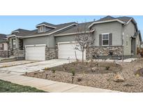 Charming townhome with stone accents, attached garages, and landscaped front yard at 3492 N Buchanan Way, Aurora, CO 80019
